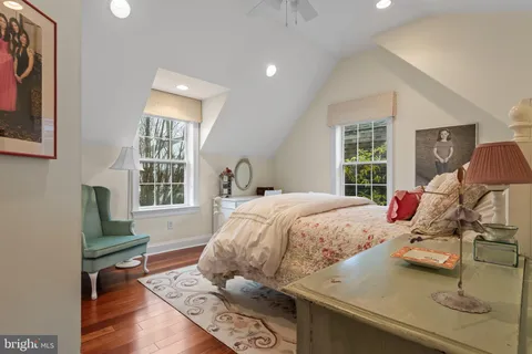 a bed room with a bed and a chair