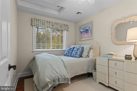 a bedroom with a bed and a mirror