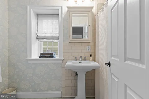 a bathroom with a sink a mirror and a window