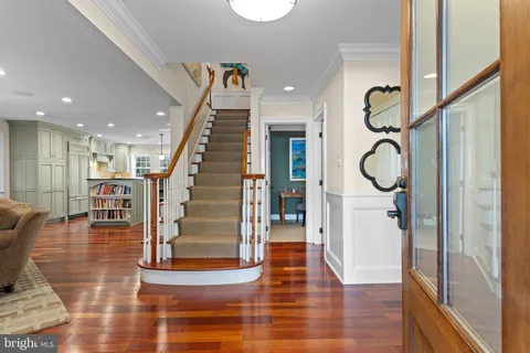 a view of entryway and hall with wooden floor