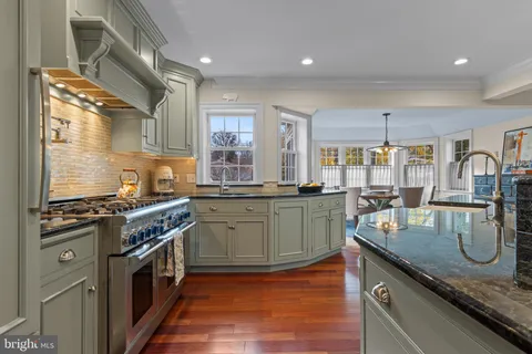 a kitchen with sink stove and cabinets