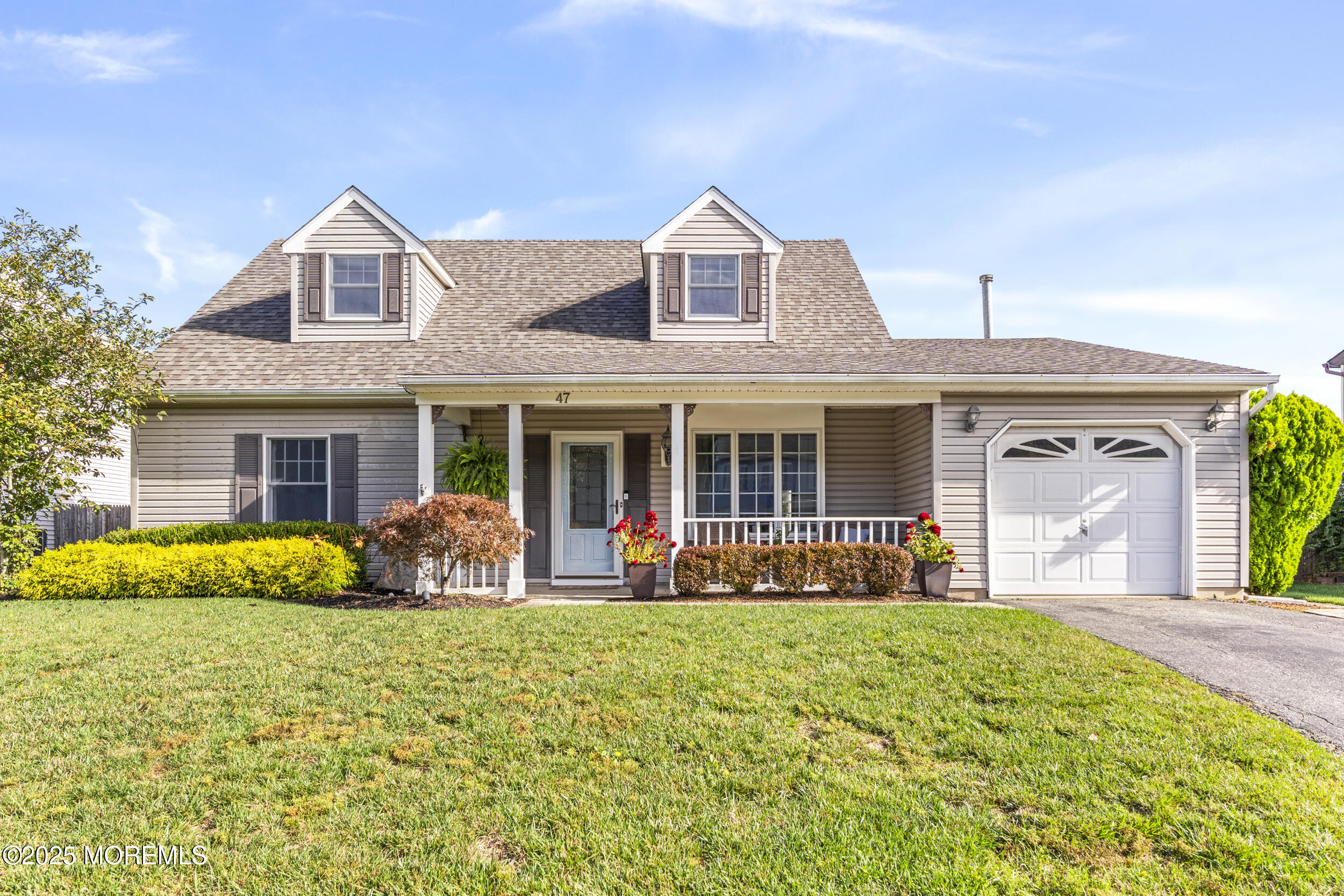 47 Yellowstone Lane Howell, NJ 07731 - Photo 1 of 47 a front view of a house with garden and porch