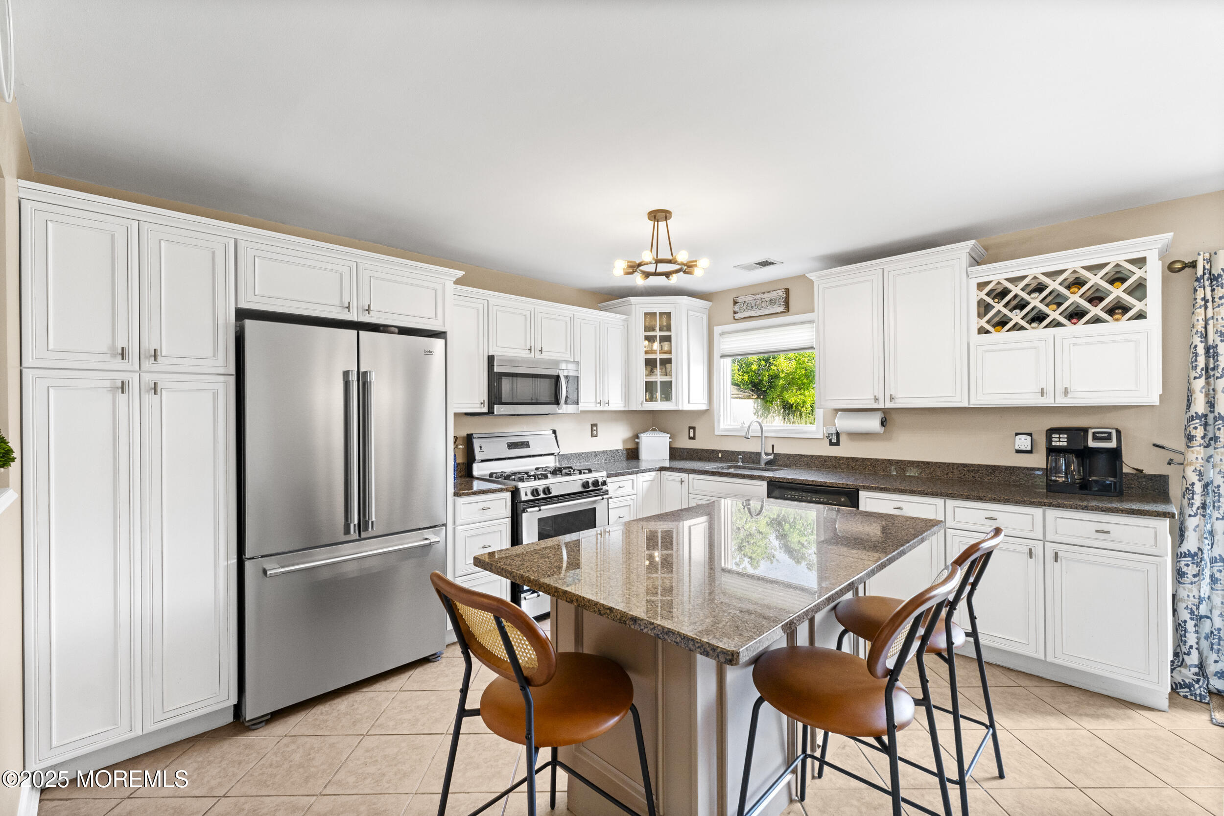 47 Yellowstone Lane Howell, NJ 07731 - Photo 11 of 47 a kitchen with a table chairs refrigerator and microwave
