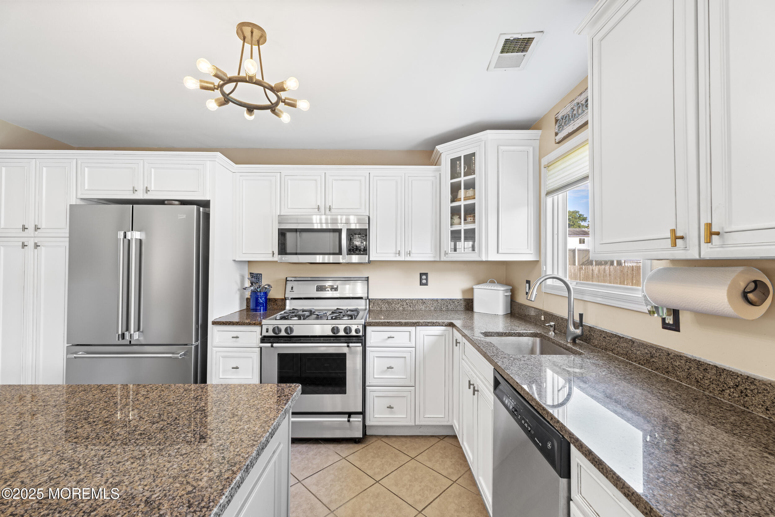 47 Yellowstone Lane Howell, NJ 07731 - Photo 13 of 47 a kitchen with stainless steel appliances granite countertop a stove sink and refrigerator