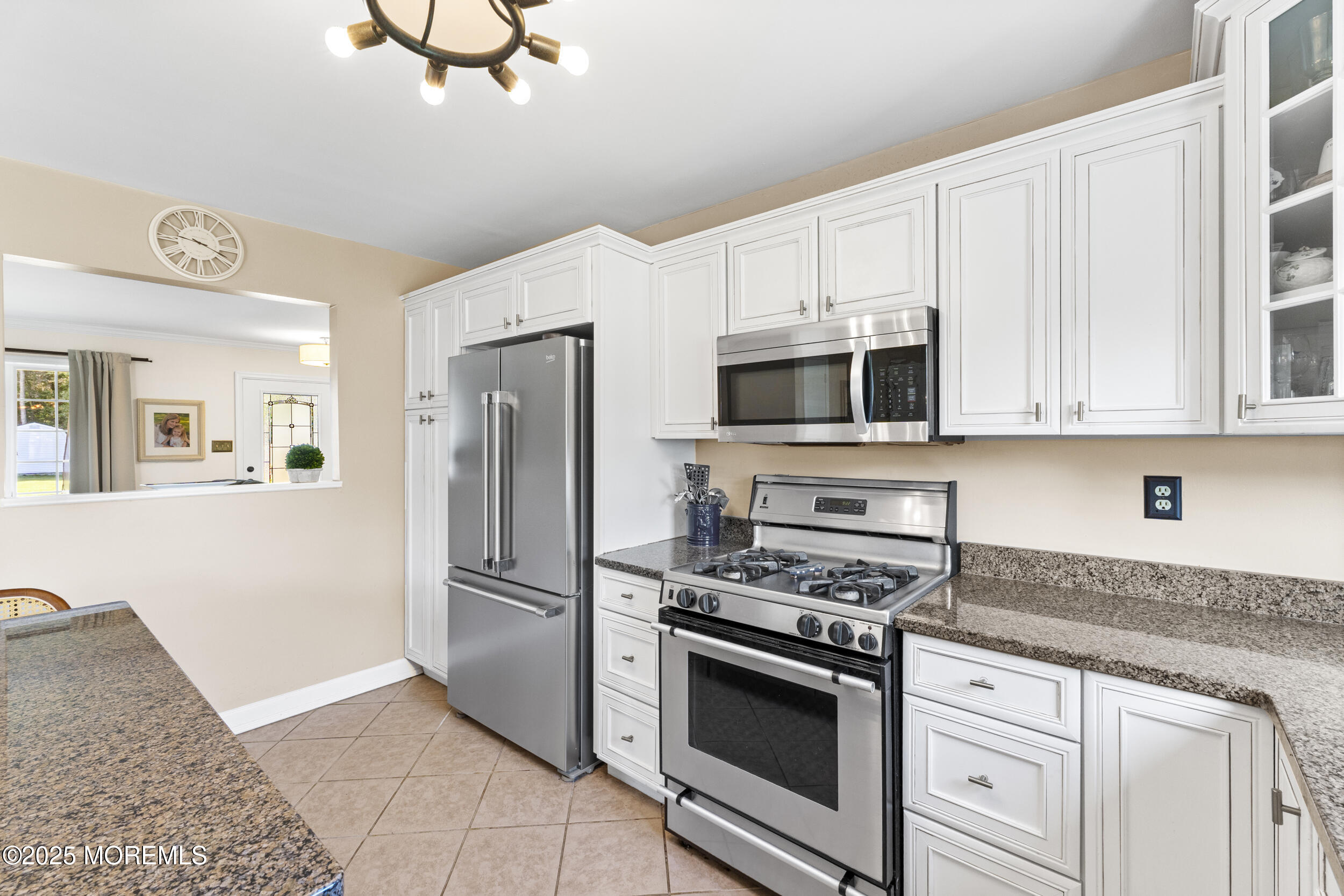 47 Yellowstone Lane Howell, NJ 07731 - Photo 14 of 47 a kitchen with stainless steel appliances white cabinets and a stove top oven