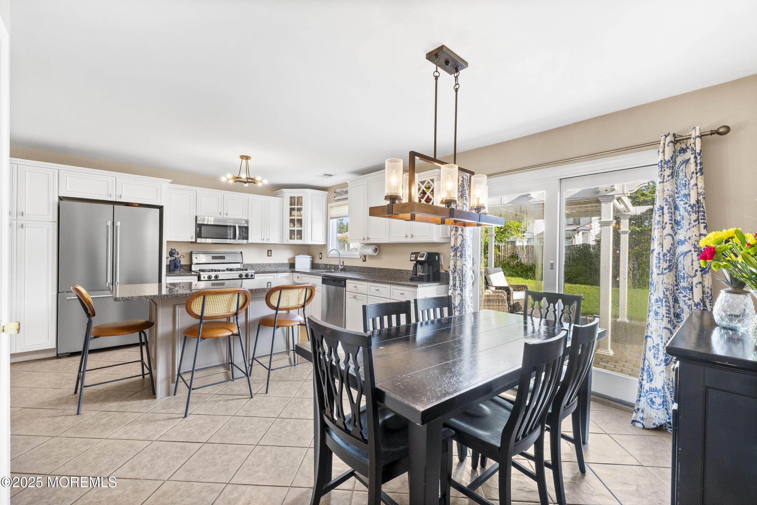 47 Yellowstone Lane Howell, NJ 07731 - Photo 17 of 47 a view of a dining room and livingroom with furniture wooden floor a chandelier