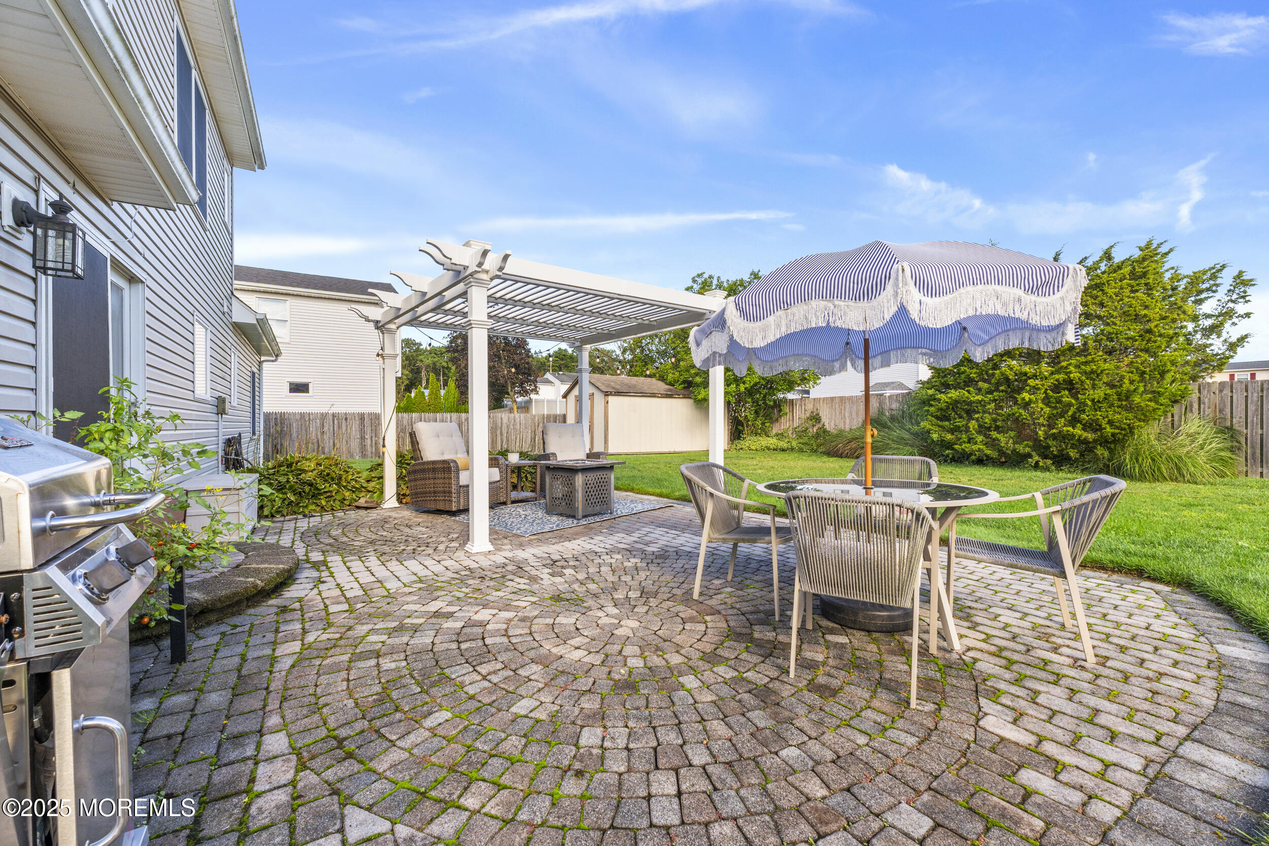 47 Yellowstone Lane Howell, NJ 07731 - Photo 35 of 47 a view of a patio with a table and chairs under an umbrella