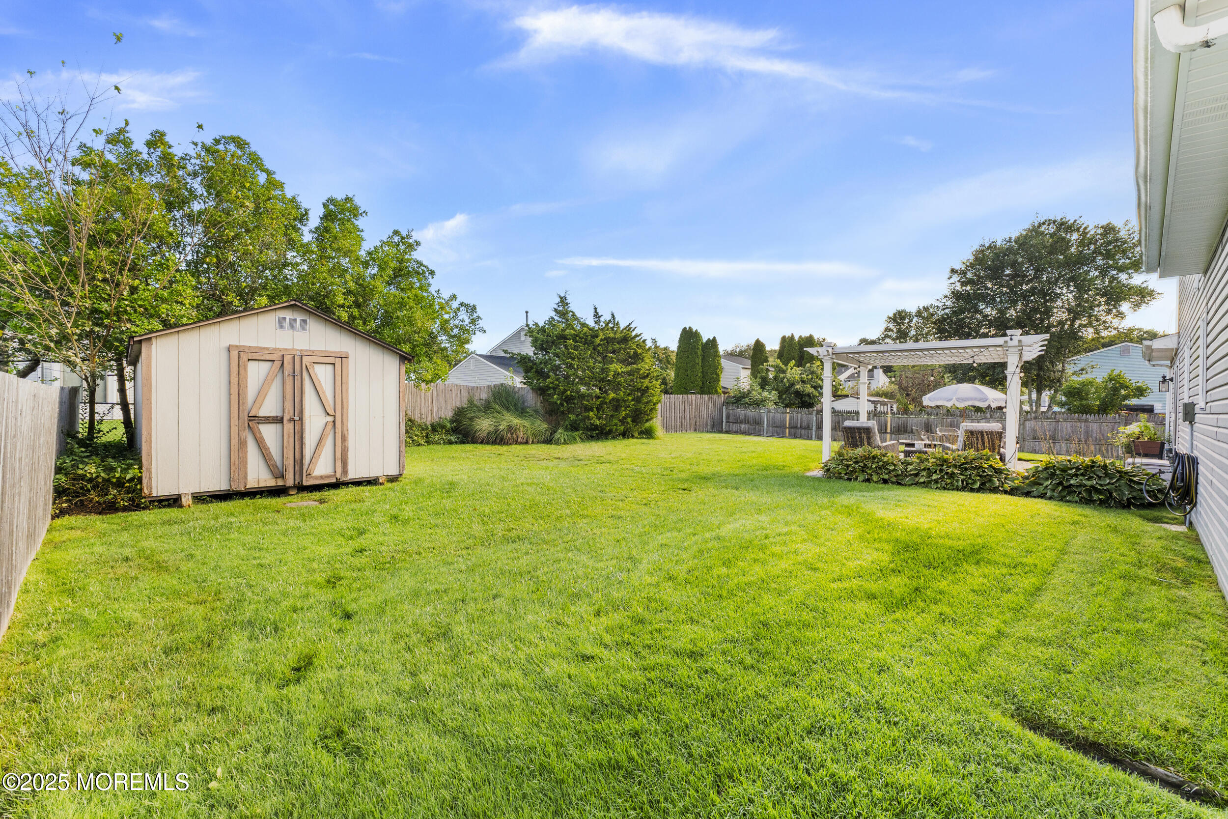 47 Yellowstone Lane Howell, NJ 07731 - Photo 37 of 47 a backyard of a house with plants and large trees