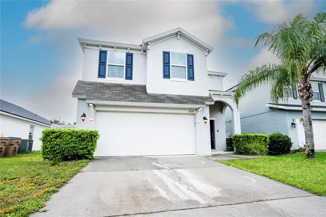 a front view of a house with a yard and garage