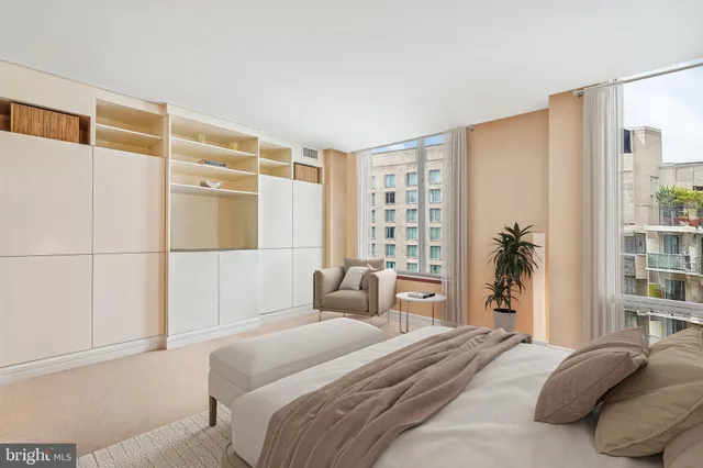 a bedroom with a large bed and a window