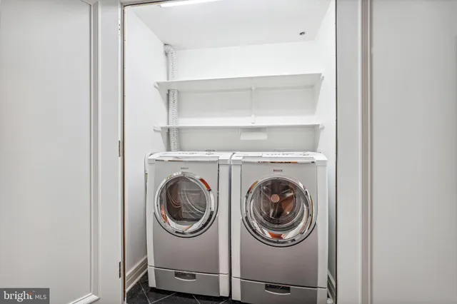 a dining room with furniture and a floor to ceiling window