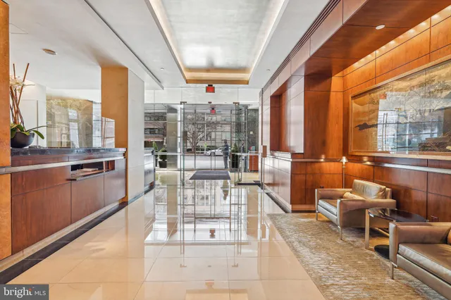 a lobby with furniture and a chandelier