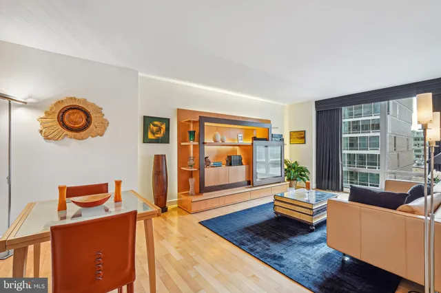 a bedroom with a bed chair and a large window