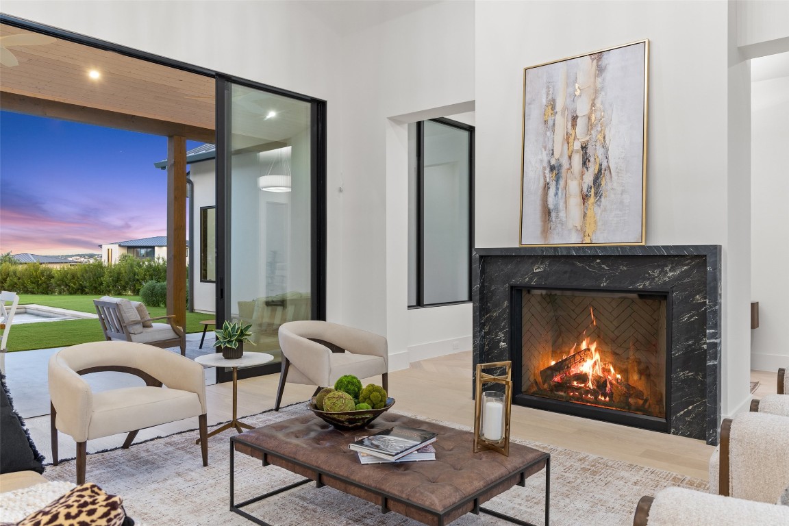 5813 Horizon Vista Way Austin, TX 78738 - Photo 15 of 38 a living room with furniture a fireplace and a floor to ceiling window
