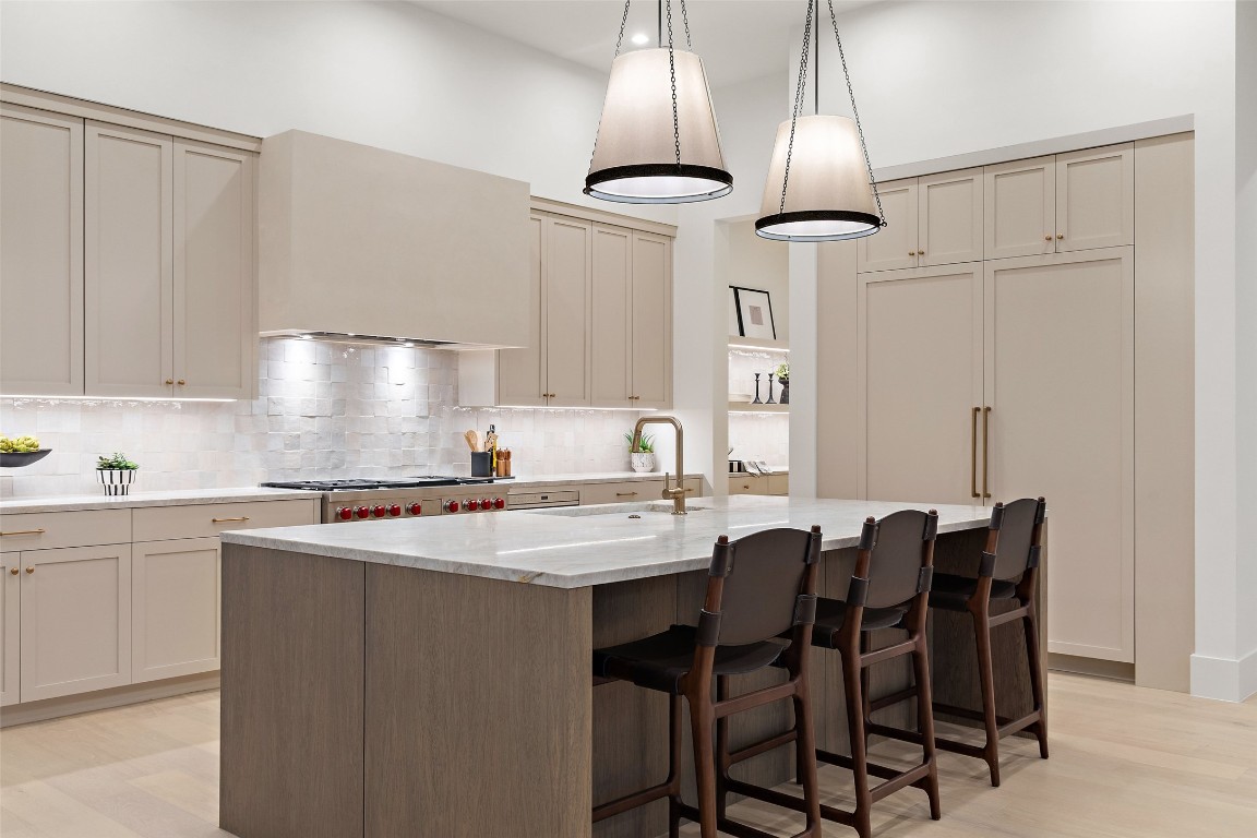 5813 Horizon Vista Way Austin, TX 78738 - Photo 18 of 38 a kitchen with a table chairs and white cabinets