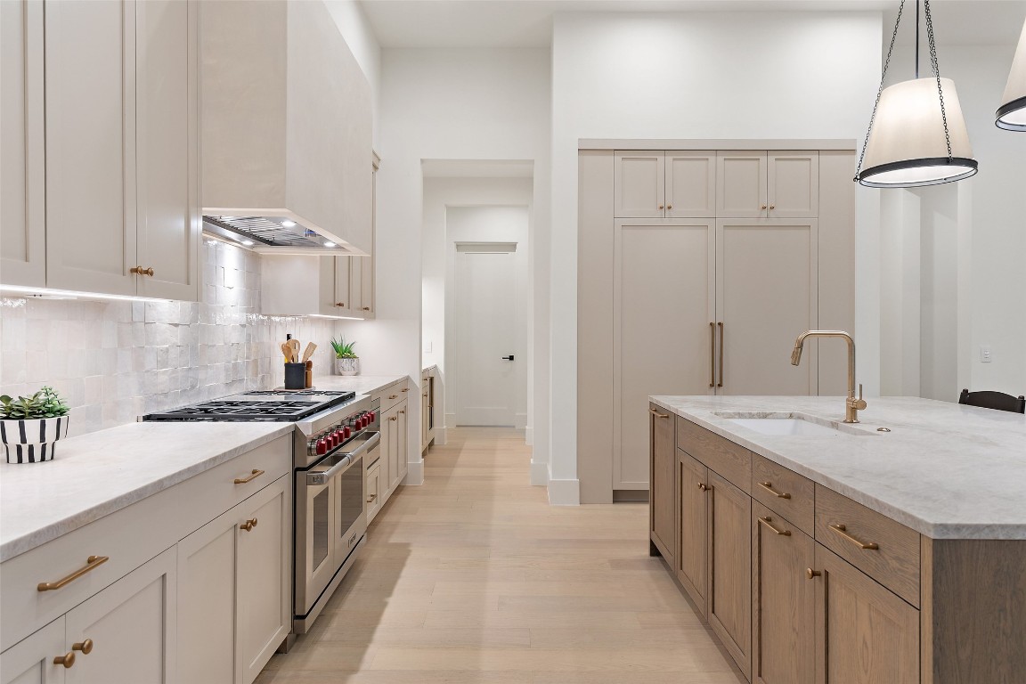5813 Horizon Vista Way Austin, TX 78738 - Photo 20 of 38 a kitchen with a sink stove and cabinets
