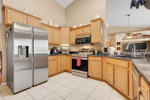 a kitchen with stainless steel appliances a refrigerator sink and microwave