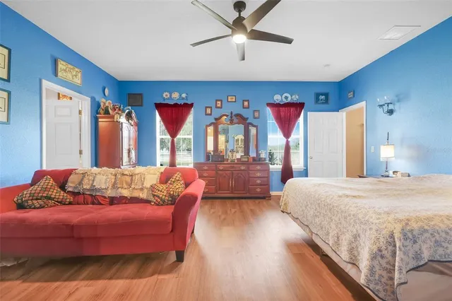 a spacious bedroom with a bed and a chandelier