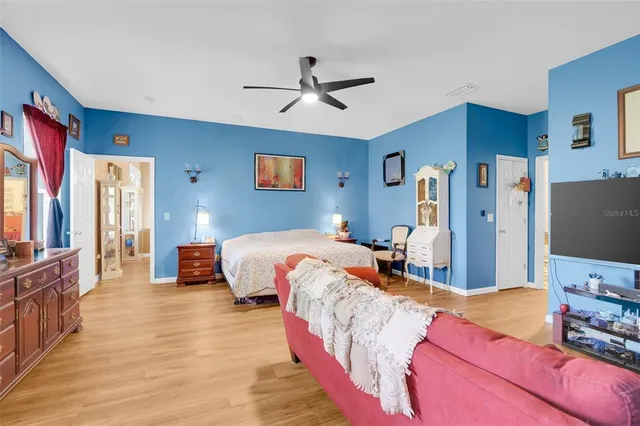 a bedroom with bed and a chandelier