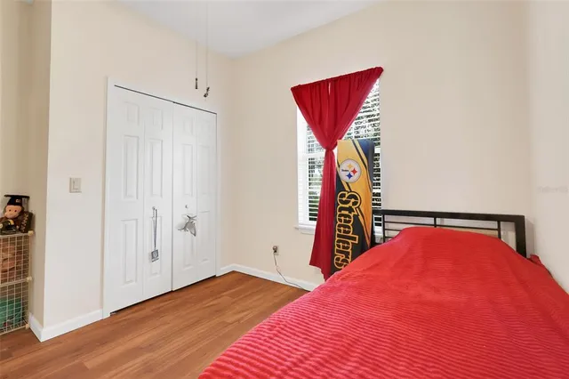 a view of a room with wooden floor and ceiling fan