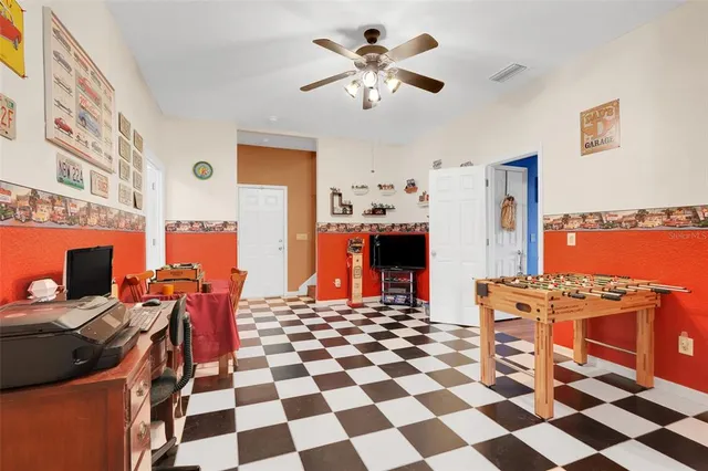 a view of a workspace with furniture and a fireplace