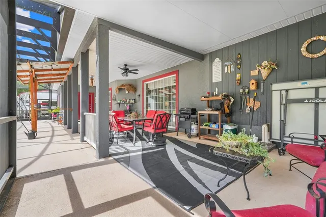 a view of a dining room with furniture large windows and wooden floor