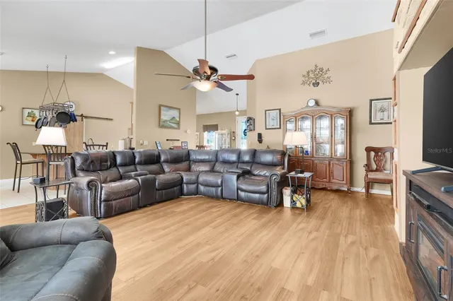 a living room with furniture wooden floor and a flat screen tv