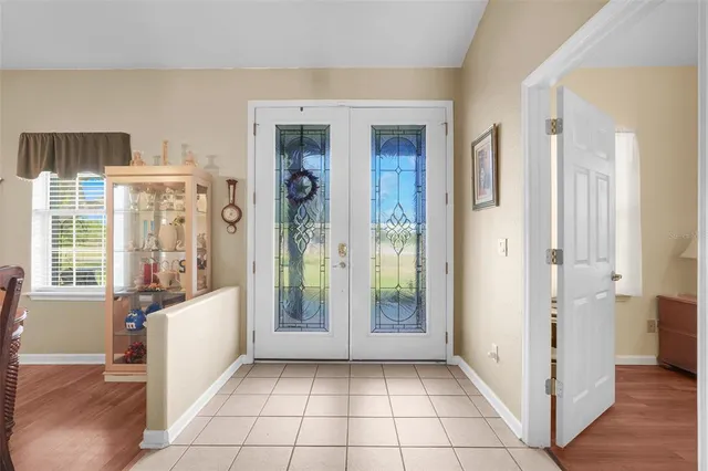a view of an entryway with wooden floor and a livingroom