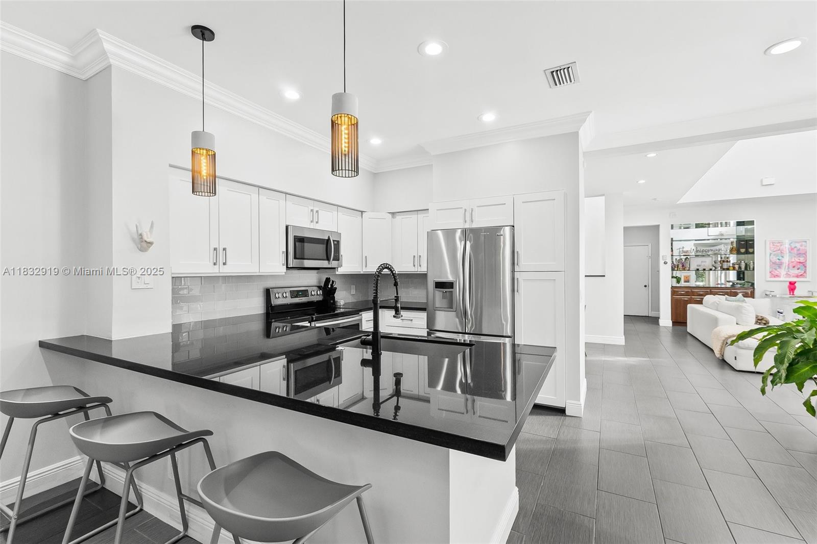 17723 Tiffany Trace Drive Boca Raton, FL 33487 - Photo 11 of 44 a kitchen with stainless steel appliances granite countertop a sink and a refrigerator