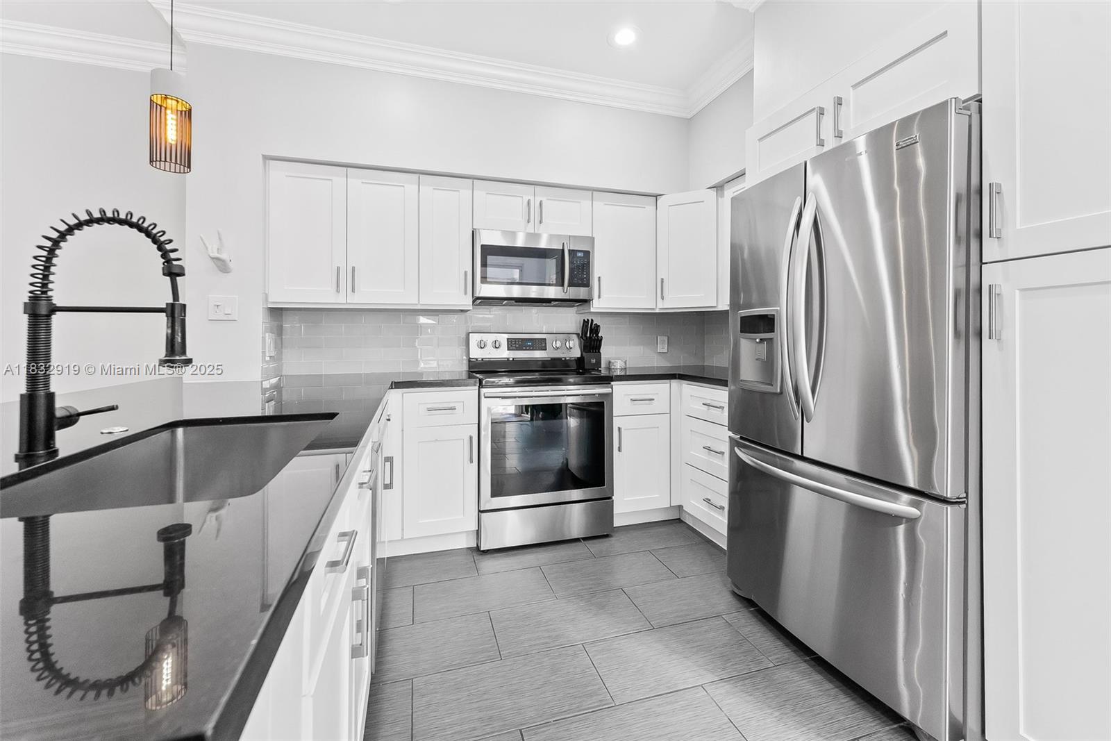 17723 Tiffany Trace Drive Boca Raton, FL 33487 - Photo 12 of 44 a kitchen with white cabinets and stainless steel appliances