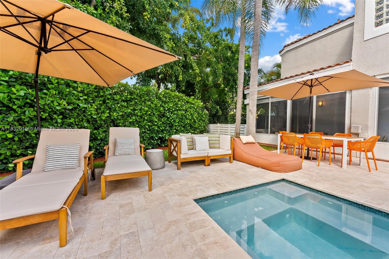 17723 Tiffany Trace Drive Boca Raton, FL 33487 - Photo 25 of 44 a view of a patio with a table and chairs under an umbrella