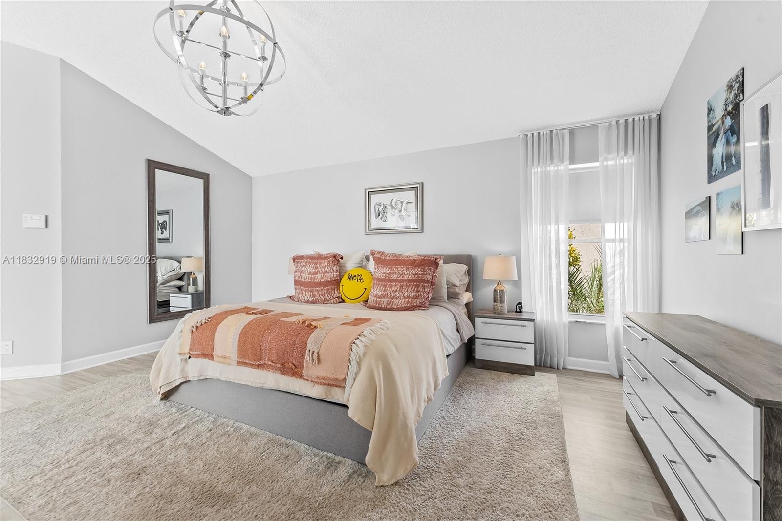 17723 Tiffany Trace Drive Boca Raton, FL 33487 - Photo 30 of 44 a bedroom with a large bed and a chandelier