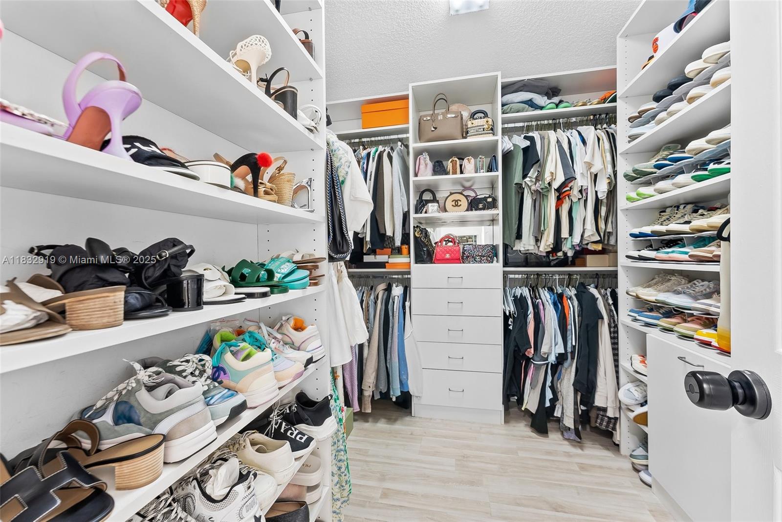 17723 Tiffany Trace Drive Boca Raton, FL 33487 - Photo 34 of 44 a view of walk in closet with clothes and shoes