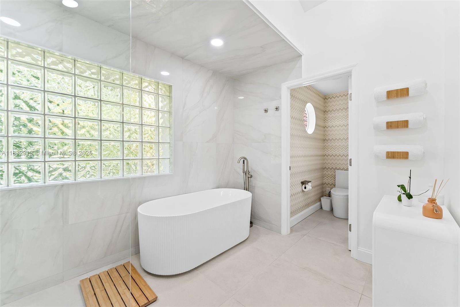 17723 Tiffany Trace Drive Boca Raton, FL 33487 - Photo 35 of 44 a bathroom with a bathtub and a sink