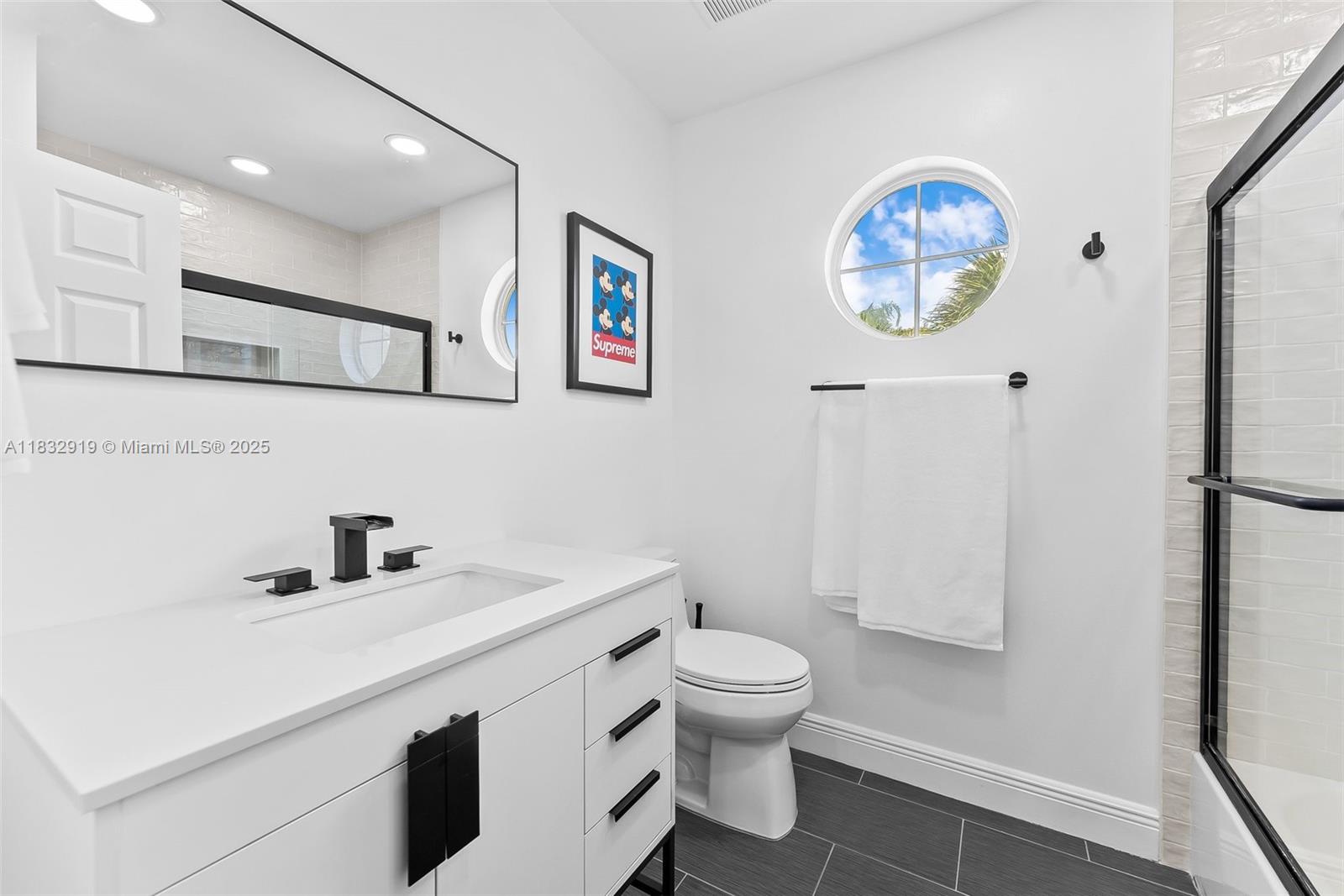 17723 Tiffany Trace Drive Boca Raton, FL 33487 - Photo 43 of 44 a bathroom with a sink a toilet and a mirror