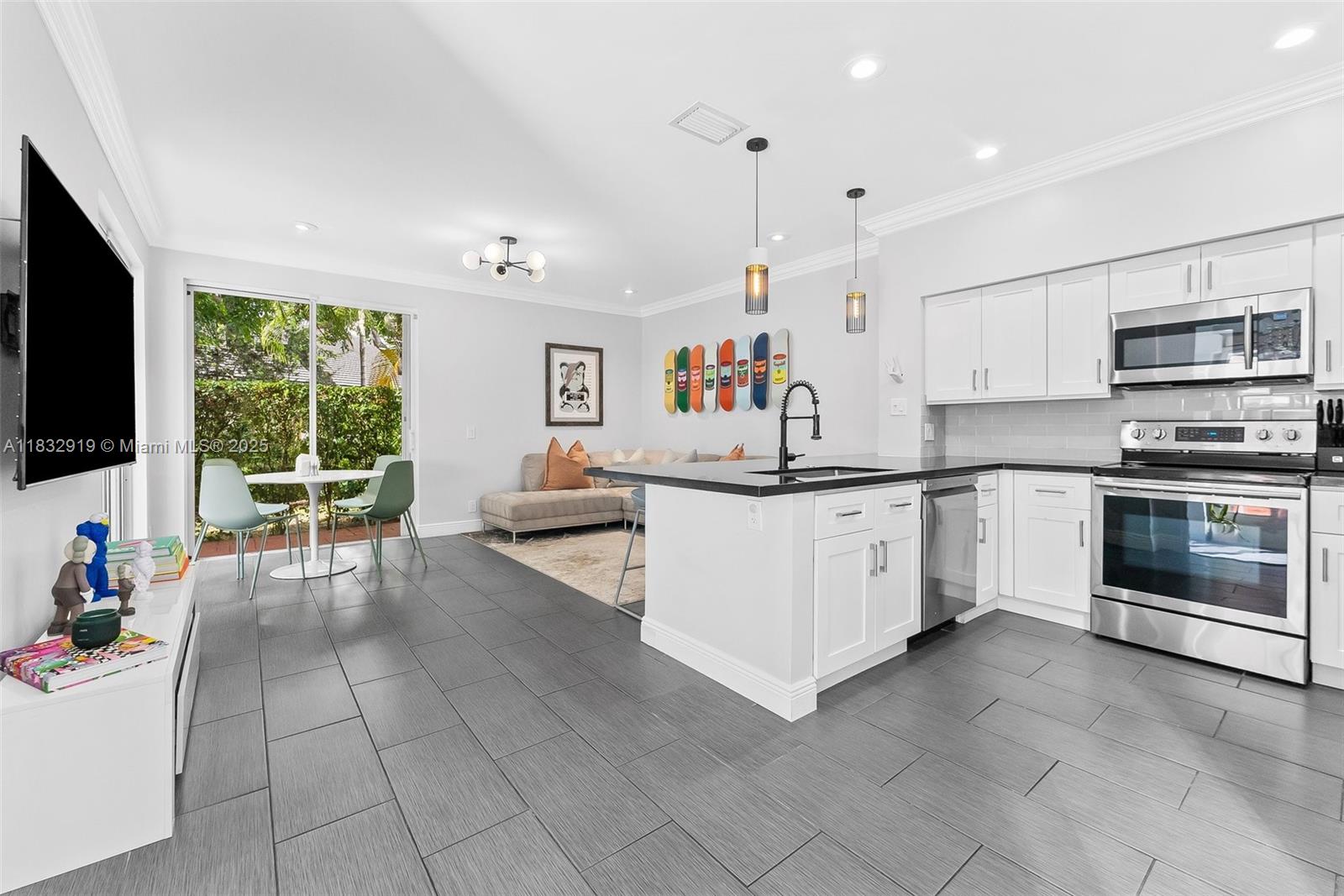 17723 Tiffany Trace Drive Boca Raton, FL 33487 - Photo 6 of 44 a kitchen with a sink stainless steel appliances and white cabinets