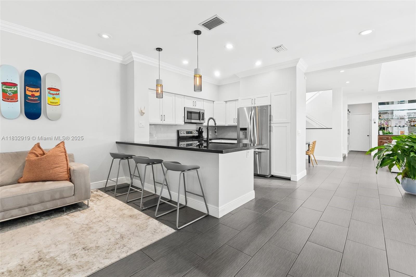 17723 Tiffany Trace Drive Boca Raton, FL 33487 - Photo 10 of 44 a kitchen with stainless steel appliances kitchen island granite countertop a sink and a refrigerator