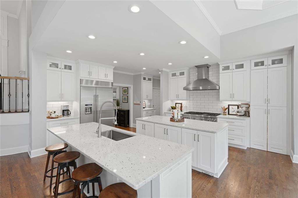 215 Bayfield Court Milton, GA 30004 - Photo 12 of 62 a kitchen with stainless steel appliances granite countertop a sink a stove a refrigerator cabinets and a dining table