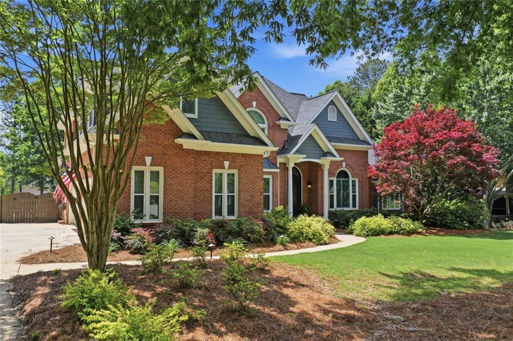 215 Bayfield Court Milton, GA 30004 - Photo 2 of 62 a front view of a house with garden