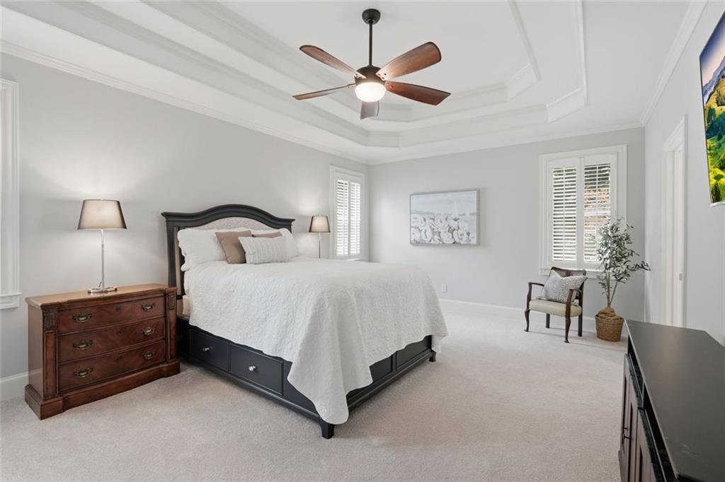 215 Bayfield Court Milton, GA 30004 - Photo 24 of 62 a bedroom with a bed and a chandelier