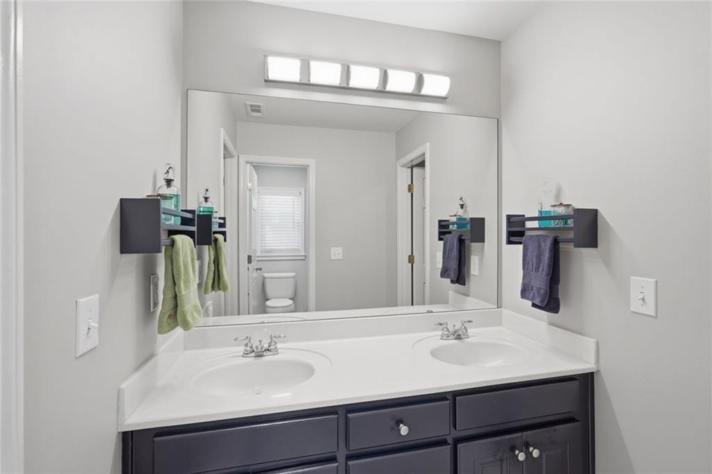 215 Bayfield Court Milton, GA 30004 - Photo 28 of 62 a bathroom with a sink and a mirror