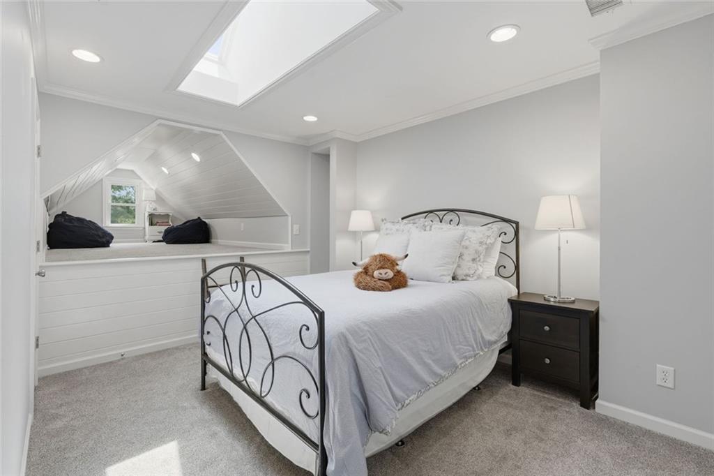 215 Bayfield Court Milton, GA 30004 - Photo 30 of 62 a bedroom with a bed and a chandelier