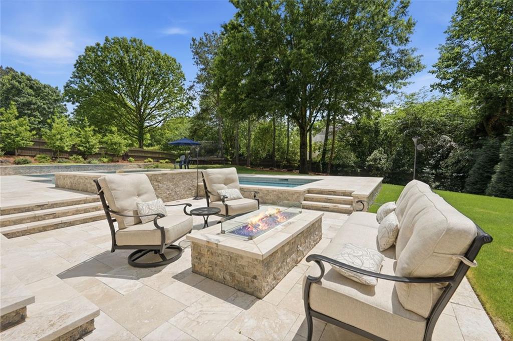 215 Bayfield Court Milton, GA 30004 - Photo 46 of 62 a view of patio with lawn chairs and large trees