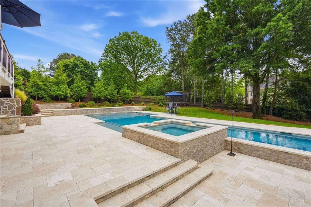 215 Bayfield Court Milton, GA 30004 - Photo 50 of 62 a view of a swimming pool with an outdoor space and seating area