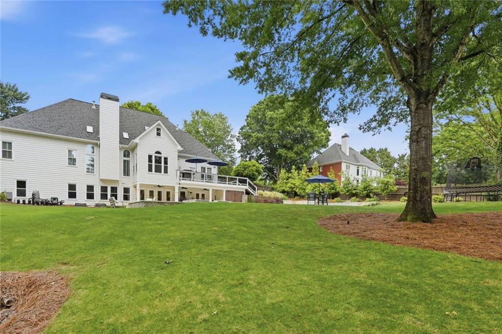 215 Bayfield Court Milton, GA 30004 - Photo 59 of 62 a view of a white house in front of a big yard with large trees