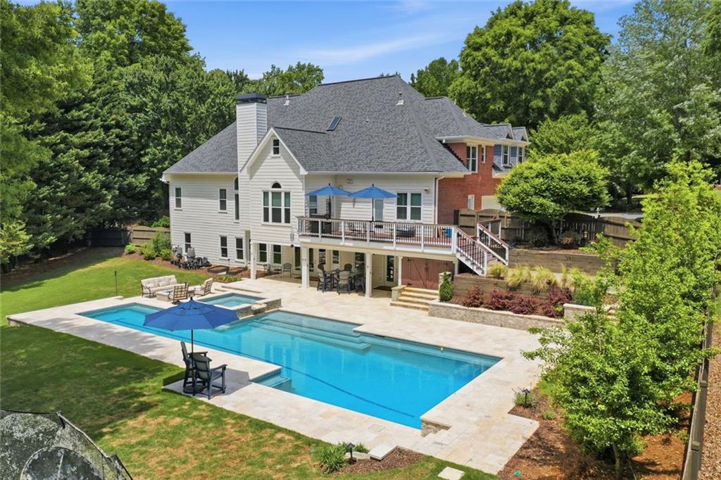 215 Bayfield Court Milton, GA 30004 - Photo 61 of 62 a view of a house with pool and chairs