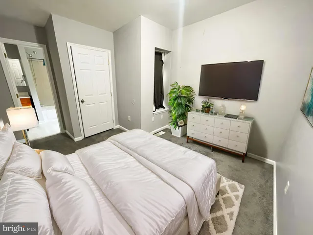 a bedroom with a bed and flat screen tv