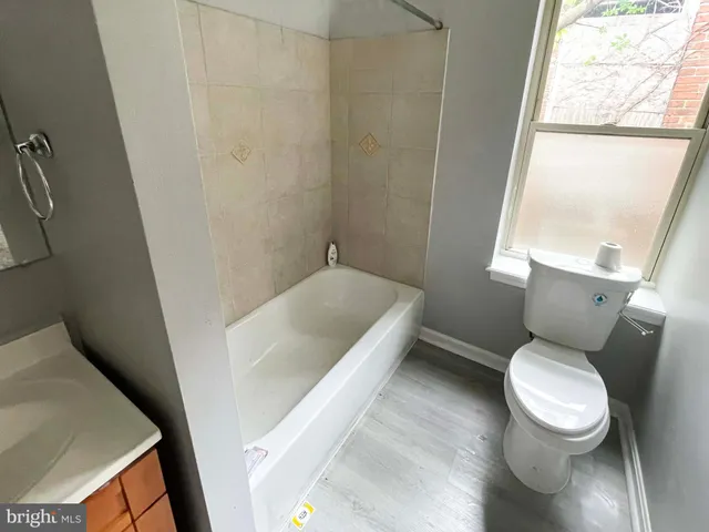 a bathroom with a toilet and a tub