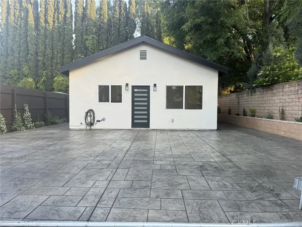 a view of a white house with a yard and garage