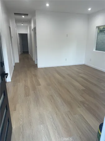 a view of a hallway with wooden floor